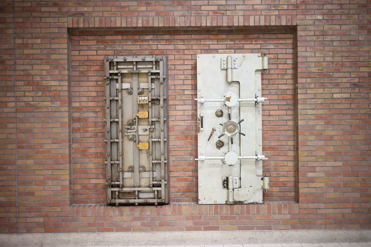 Two steel vault doors set into a brick wall.