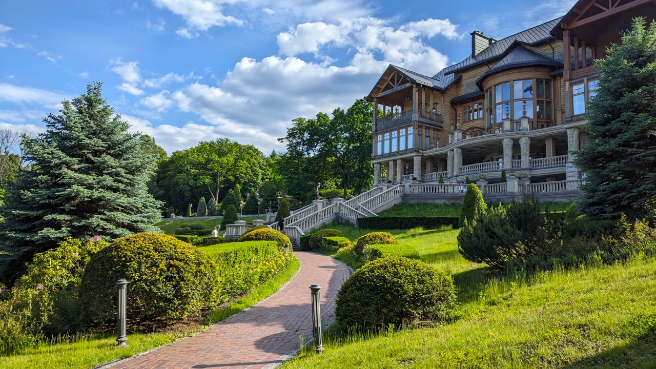 A grand manor house with manicured gardens.