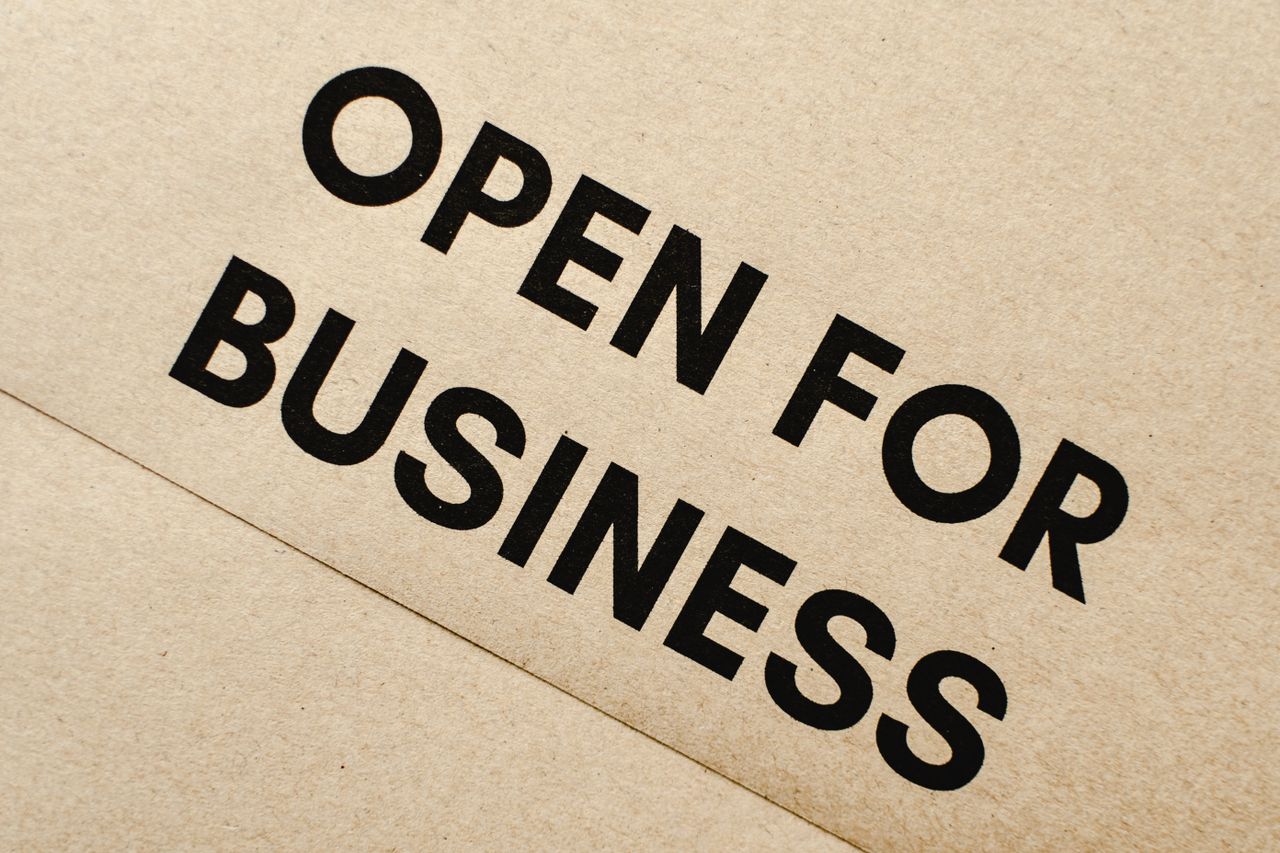 A cardboard sign reading 'Open for Business'.